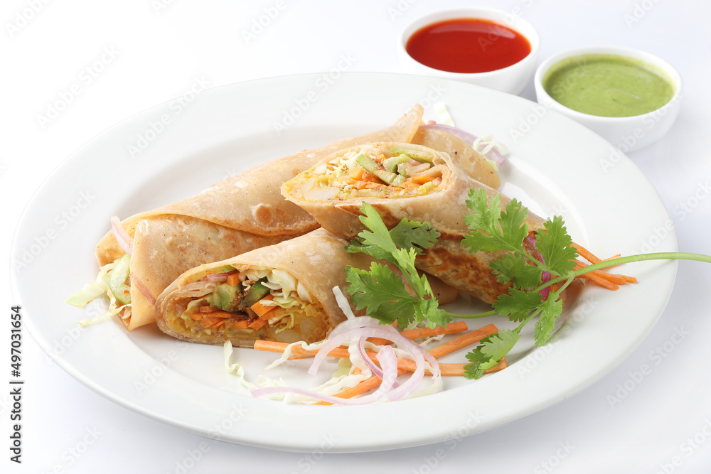 Indian Frankie Veg chapati Wrap / Kathi Roll, served in a plate with sauce & mint chutney. selective focus Indian Frankie Veg chapati Wrap / Kathi Roll, served in a plate with sauce & mint chutney. selective focus