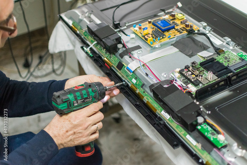 technician repairing a television.