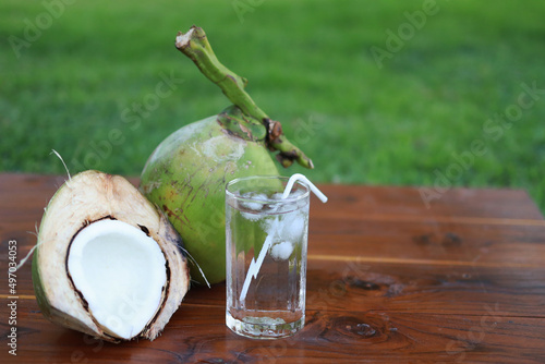 Green coconut and milk  on wood table