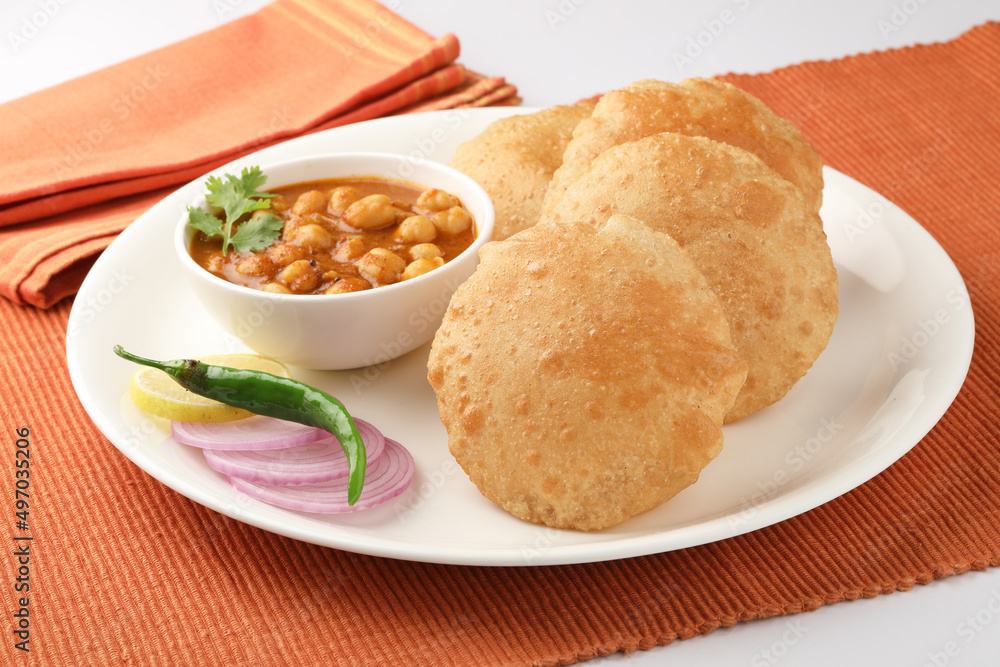 Puri and Chole traditional Indian food
Indian dish spicy Chick Peas curry also known as Chola/Chana Masala or commonly Chole, served served with fried puri or poori Puri and Chole traditional Indian food
Indian dish spicy Chick Peas curry also known as Chola/Chana Masala or commonly Chole, served served with fried puri or poori