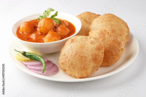 Indian food - Puri Bhaji. North India. Puri is a deep fried bread made from whole wheat flour & Served with Potato curry , bhaji or alu ki sabji.or Potato curry or dum alu curry photo