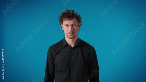 Portrait funny arrogant curly male touching eyebrows fooling having fun posing isolated