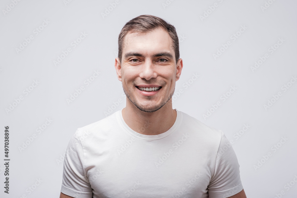 portrait of smiling caucasian man in white T-shirt on white grey background, portrait of smiling caucasian man in white T-shirt on white grey background,