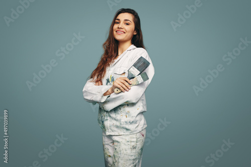 Female painter smiling at the camera in a studio photo