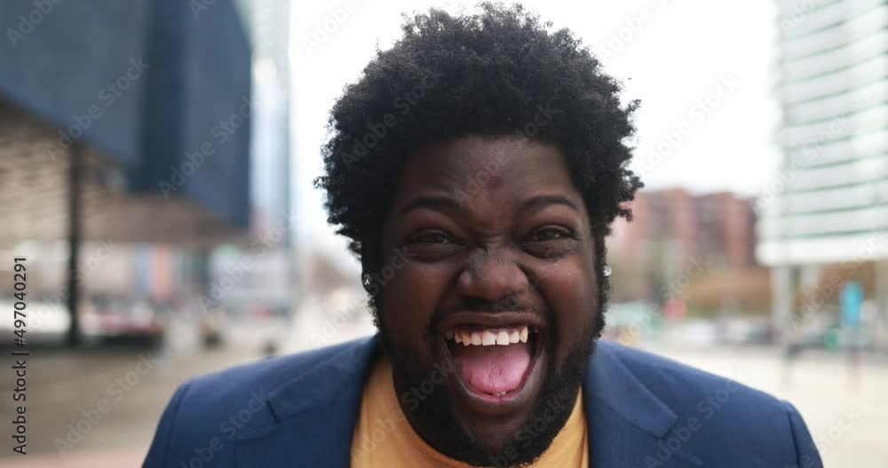 Happy african plus size man smiling on camera outdoor Happy african plus size man smiling on camera outdoor