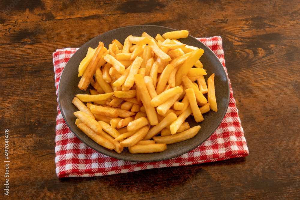 top view of a plate of french fries on a wooden table top view of a plate of french fries on a wooden table