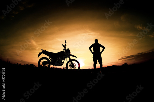 Men's silhouettes and touring motocross bikes. Park to relax in the mountains in the evening. adventure travel and leisure concept