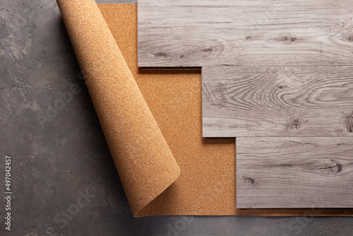 Laminate wood floor at cork background texture. Wooden laminate floor and corkboard