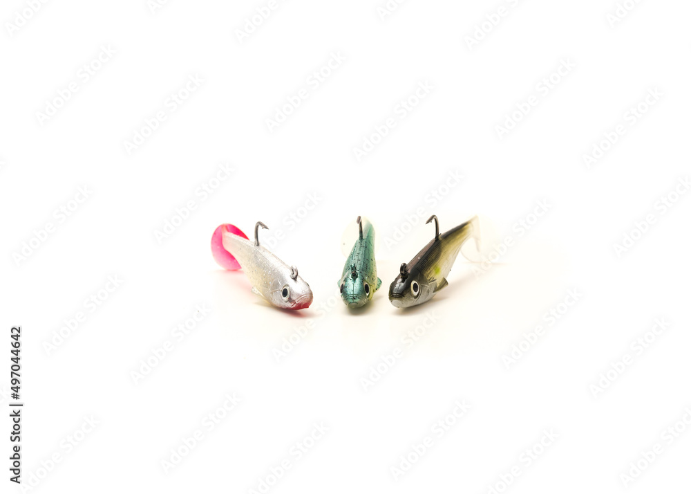 Three Jig Head Shad Soft Fishing Lures with hook and Paddle Tail Swimbaits isolated on white background Three Jig Head Shad Soft Fishing Lures with hook and Paddle Tail Swimbaits isolated on white background