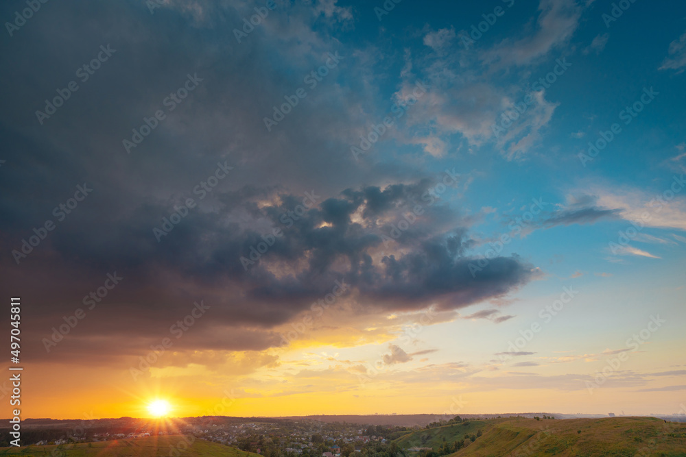 A beautiful sunset sky with stormy rainy sky panoramic view. Breathtaking moment of oncoming rain. Wide-angle landscape.