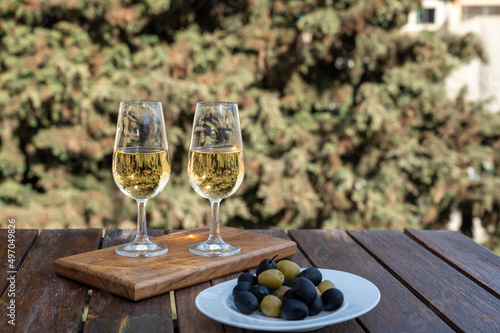 Tasting of Spanish sweet and dry fortified Vino de Jerez sherry wine with view on roofs and houses of old andalusian town photo