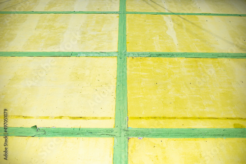 Yellow cells and green lines. Wall is painted. Structure is made of rectangles.
