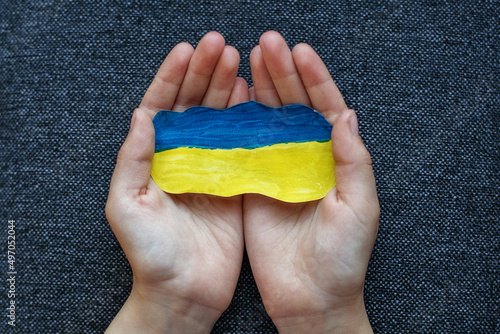 Children s hands with the flag of ukraine. Antiwar support concept. Stop war.