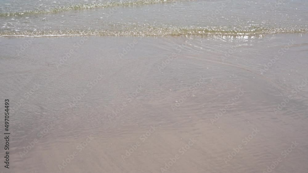 Wave of tropical sea splashing on sand beach