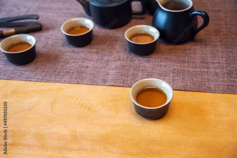 Obraz premium Cup and tea set with tea on table