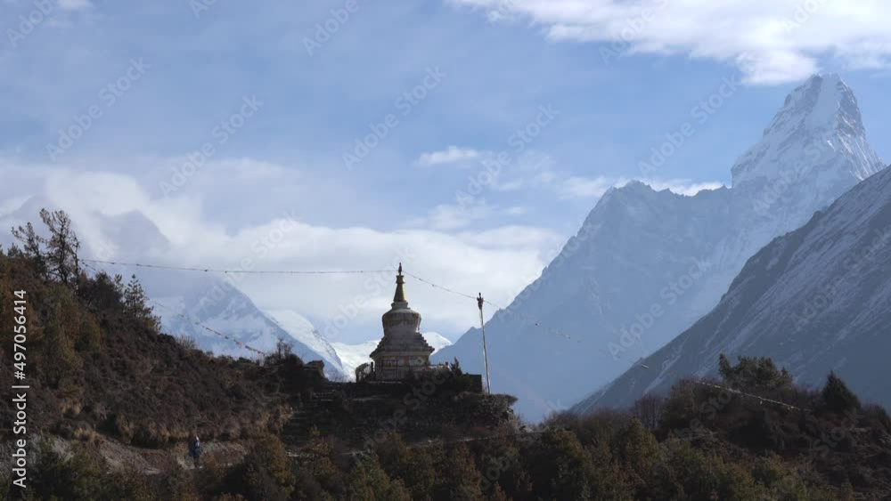 A Buddhist stupa on a mountain ridge with AmaDablam in the background. A Buddhist stupa on a mountain ridge with AmaDablam in the background.