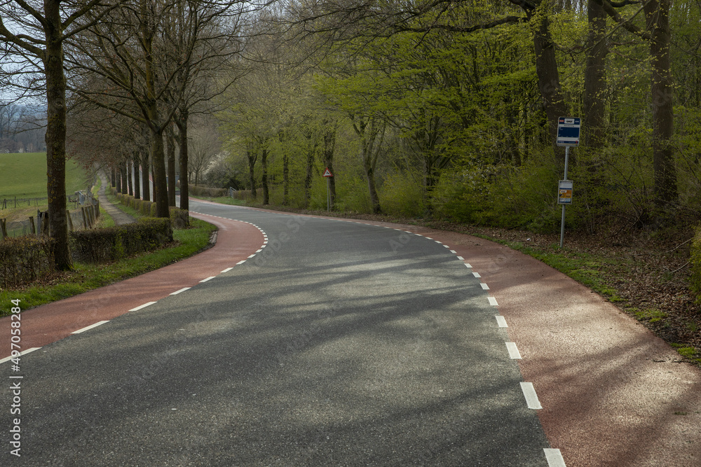 Hills of Limburg Netherlands near Gulpen. Spring. Winding road.