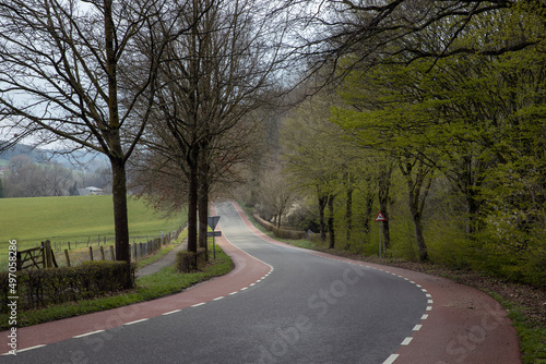 Hills of Limburg Netherlands near Gulpen. Spring. Winding road.
