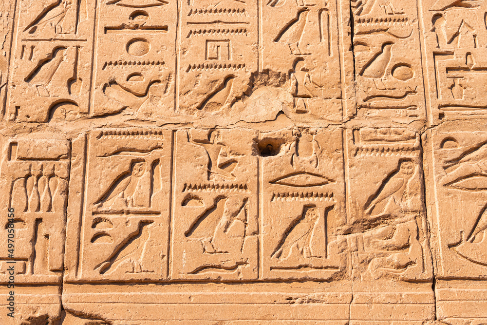 hieroglyphs carved in sandstone wall in Karnak temple in Luxor. Egyptian heritage and history concept hieroglyphs carved in sandstone wall in Karnak temple in Luxor. Egyptian heritage and history concept