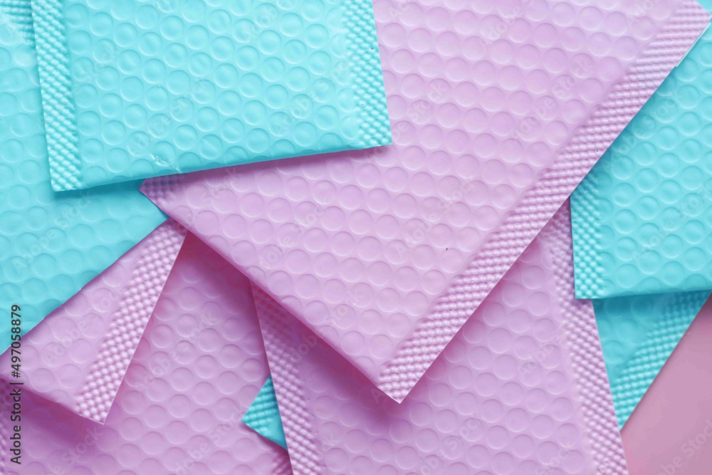 Fototapeta premium pink and green color paper bubble envelope on table 