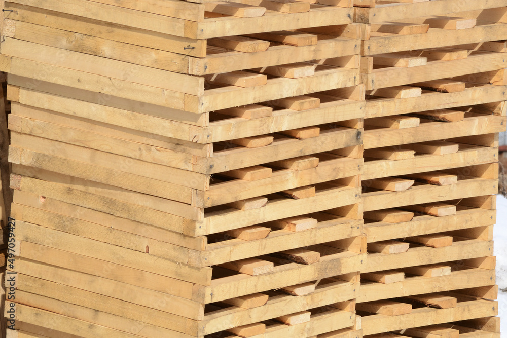 Wooden pallets piled up in a warehouse. Wooden pallets piled up in a warehouse.