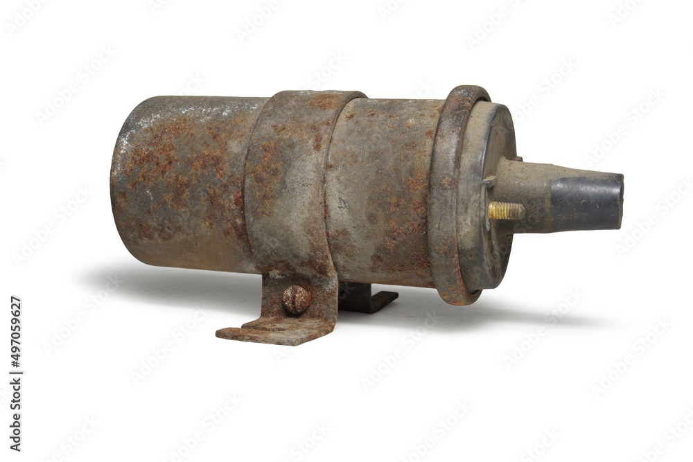 conventional ignition coil in clamp with holes for fixing the coil. old, worn. on white background, with clipping path conventional ignition coil in clamp with holes for fixing the coil. old, worn. on white background, with clipping path