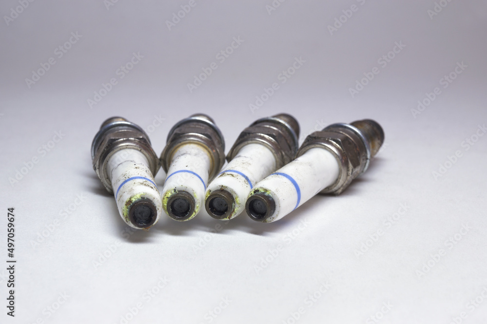 spark plugs kit. old and dirty plugs, showing terminals spark plugs kit. old and dirty plugs, showing terminals