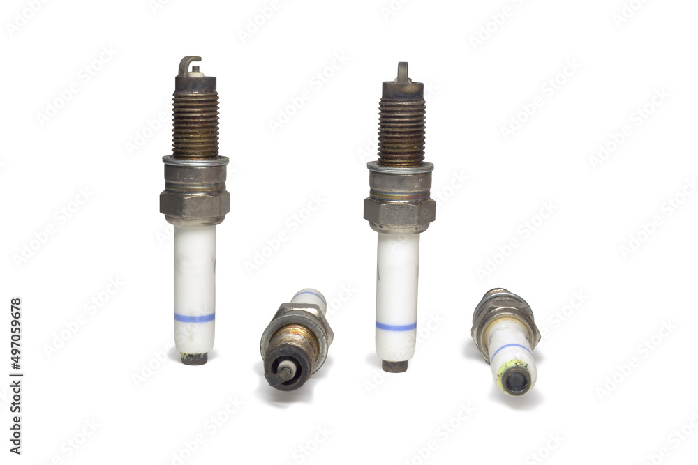 spark plugs kit, showing all sides, old, on white background, with clipping path spark plugs kit, showing all sides, old, on white background, with clipping path