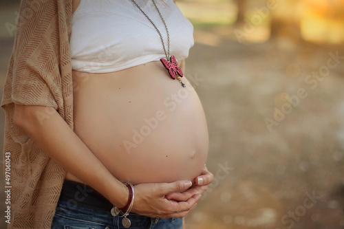 Pregnant woman hugging belly. Beautiful belly waiting for the birth of her baby. photo