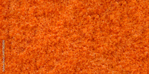 Background of fresh grated carrots, the texture of orange carrot pieces fills the background, the concept of organic food