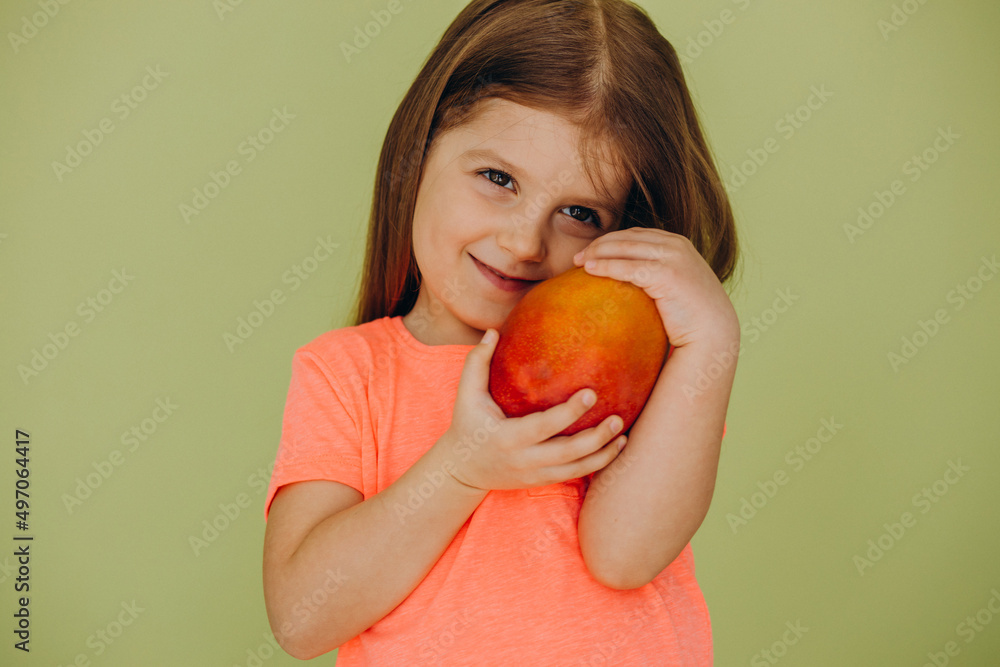 Little girl isolated holding mango Little girl isolated holding mango