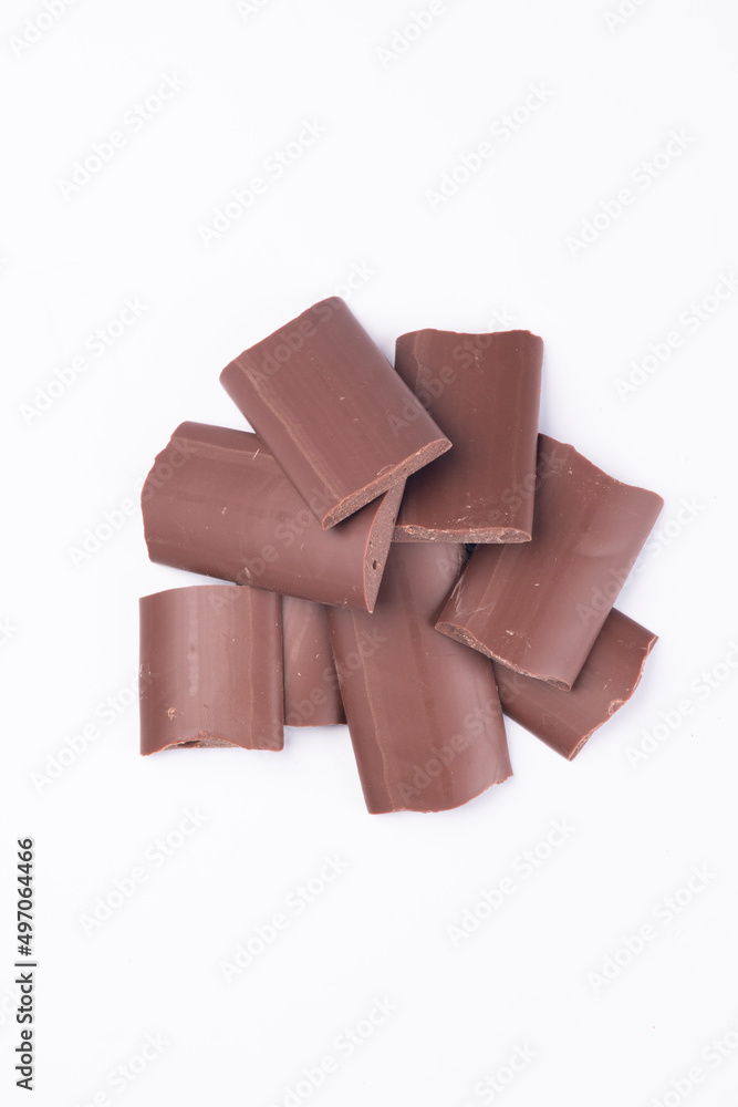 milk chocolate kibbles, pieces top view close up isolated on white background
