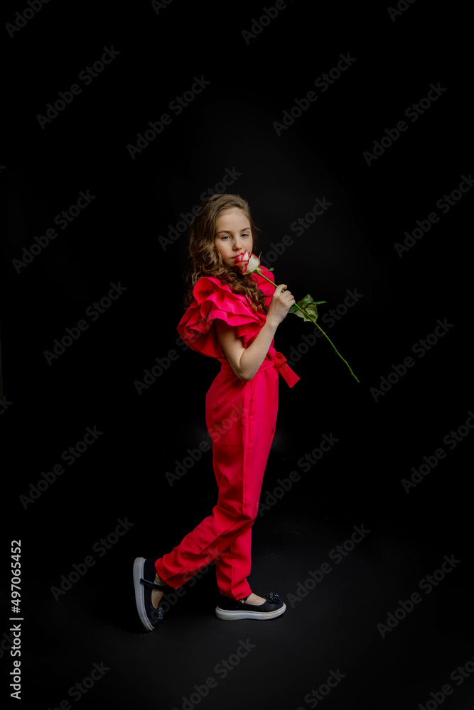 girl, dressed in a bright pink outfit, on a black background girl, dressed in a bright pink outfit, on a black background