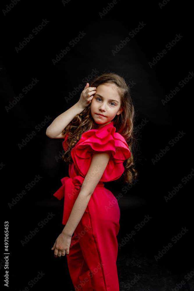 girl, dressed in a bright pink outfit, on a black background girl, dressed in a bright pink outfit, on a black background
