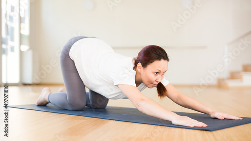 Pregnant woman is engaged in yoga. Baby asana or Balasana