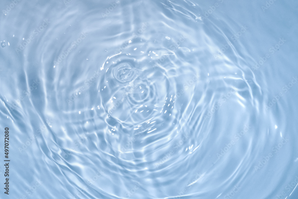 Circles on water. Blue round shadows. Blurred background made with water and light in monochrome. Pureness and freshness concept. Circles on water. Blue round shadows. Blurred background made with water and light in monochrome. Pureness and freshness concept.