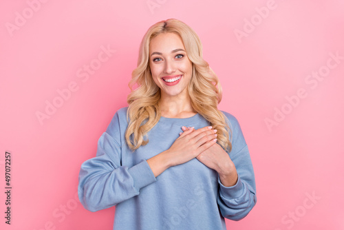 Photo of young lovely girl arms on heart soul hope promise thankful isolated over pink color background