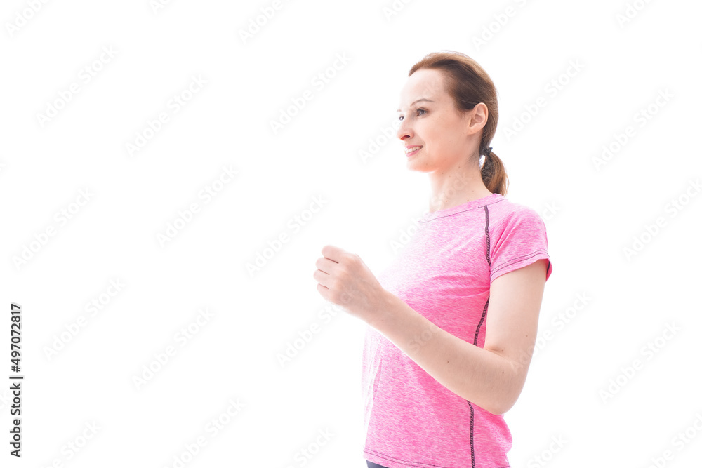 ランニングをする笑顔の若い女性 ランニングをする笑顔の若い女性
