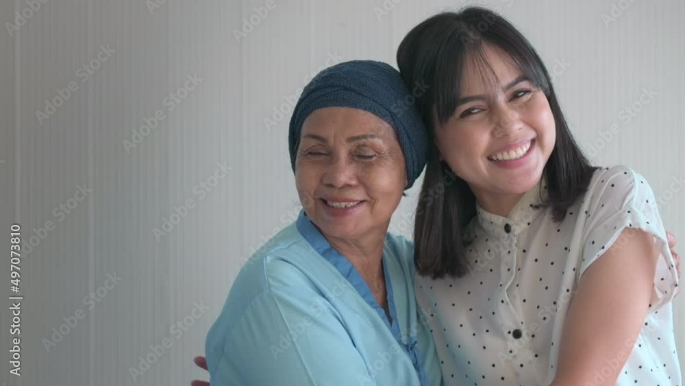 Cancer patient woman wearing head scarf and her supportive daughter in hospital, health and insurance concept Cancer patient woman wearing head scarf and her supportive daughter in hospital, health and insurance concept