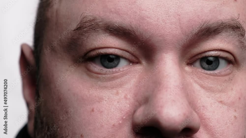 The man looks at the camera. Close-up. The upper part of the face. A middle-aged man, forty years old. The man looks at the camera. Close-up. The upper part of the face. A middle-aged man, forty years old.