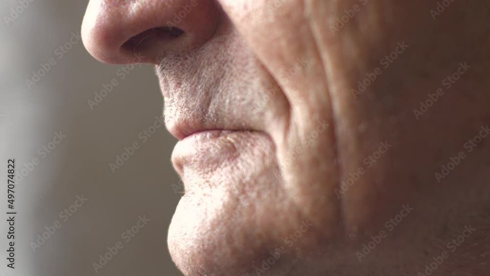 Close-up part of the face of a Caucasian pensioner in profile. Lips of an elderly person. Wrinkled face of an elderly over 70 years old. Selective focus.Real people Close-up part of the face of a Caucasian pensioner in profile. Lips of an elderly person. Wrinkled face of an elderly over 70 years old. Selective focus.Real people