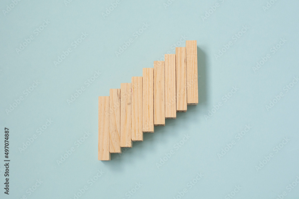 Obraz premium Wooden blocks cubes are stacked in ascending order . Steps. Growth and construction concept.
