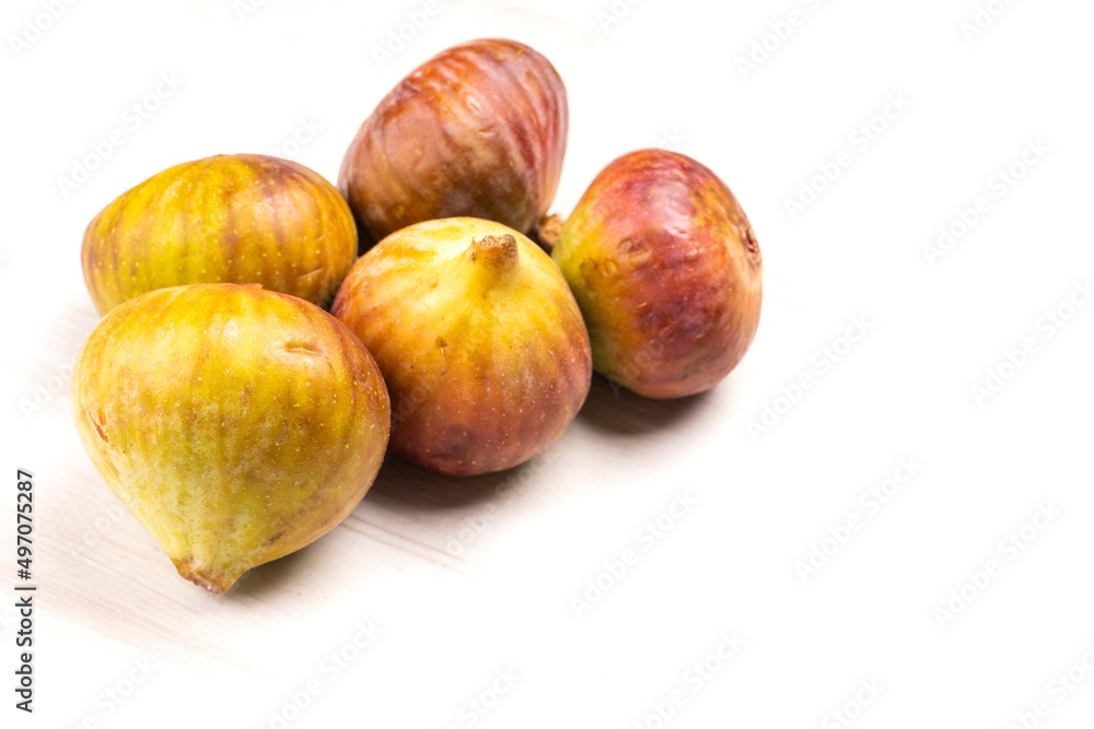 Freshly ripe figs. Healthy Mediterranean fig fruit. Fresh figs on a dark background. Beautiful blue violet figs with leaves, copy space, closeup Freshly ripe figs. Healthy Mediterranean fig fruit. Fresh figs on a dark background. Beautiful blue violet figs with leaves, copy space, closeup