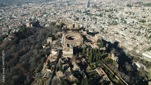 Drone circling pov of Charles V Palace inside Alhambra citadel with cityscape in background, Granada in Spain. Aerial orbit