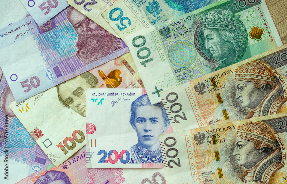 Obraz premium Paper money, Ukrainian hryvnia and Polish zloty. Currency exchange for refugees and emigrants from Ukraine.