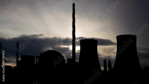 Philippsburg Nuclear Power Plant, Time Lapse at Sunrise with Fast Clouds and Dark Silhouette of Big Chimneys, Germany photo