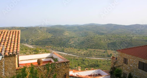 Beautiful panoramic view over residential houses in Castellon province, Cervera del Maestre, Spain. Mountain range covered with lush green vegetation visible in a distance. photo
