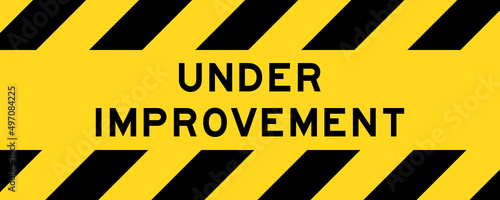Yellow and black color with line striped label banner with word under improvement