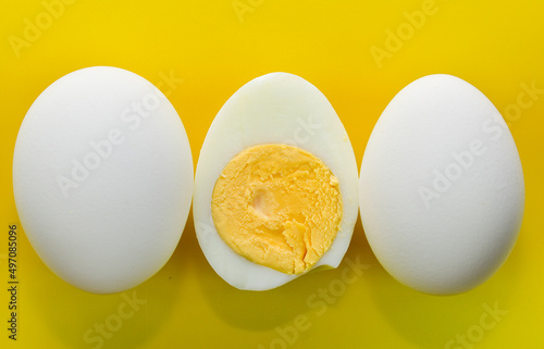 composition of chicken eggs on a yellow background. Top view. Close-up