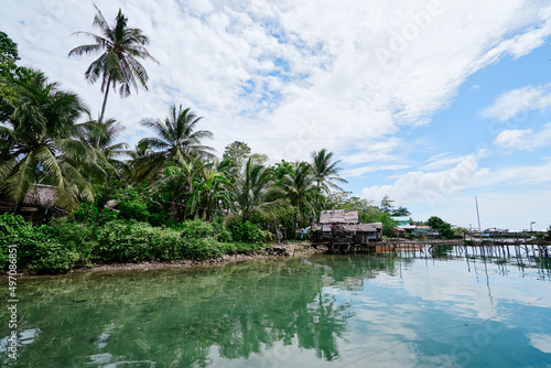 Wooden houses on stilts, tropical village on the sea shore.